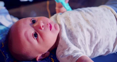 A mother is playing with her baby while preparing her take-out milk Stock-Footage 170732056