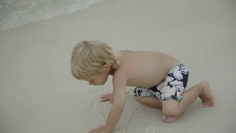 Mother playing with her young son in the beach waters 4k Stock Footage 81491326