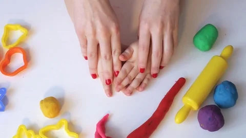 Mother playing with modelling clay Stock Footage 71324951