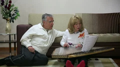 Mother playing qanun, turkish string instrument, father and son listens Video stock 23340473