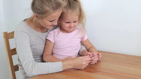 Mother playing with spinner Stock Footage 77213877