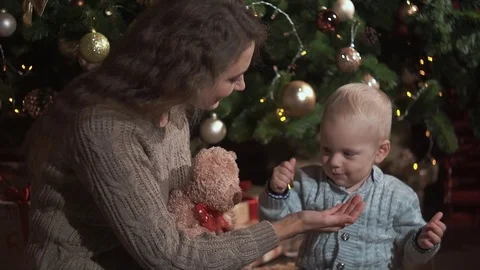 Mother playing with teddy bear with her child Stock-Footage 70078524