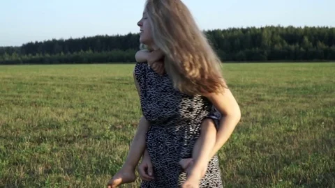 Mother plays with son at field at sunset. Slow mo Video stock 80343634