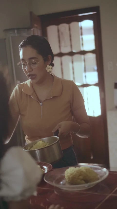 Mother preparing and serving dinner for family Stock Footage 341893054