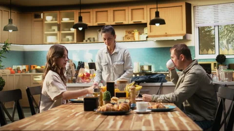 Mother preparing packed lunch in box for daughter at school Stock Footage 325819906