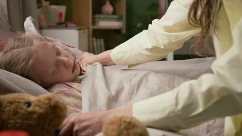 Mother Pulling up Daughters Blanket and Giving Kiss, Sick Girl Napping in Bed Stock Footage 335469693