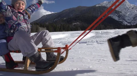 Mother Pulls Her Son And Daughter On Sledge On A Sunny Winter Day Stock Footage 45305858