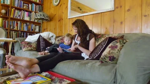 Mother reading book to son Stock Footage 80621574
