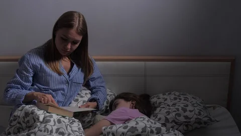 Mother reads before bed Stock Footage 107044847