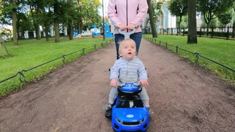 Mother rolls the child Stock Footage 136414384