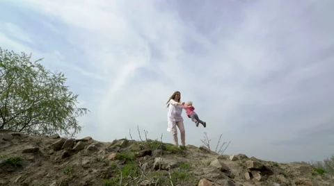 Mother rotating twisting making circle with her little daughter Stock Footage 62466234