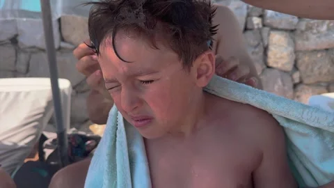 Mother is rubbing, drying to her son who is swam with towel. Sea and summer.. Stock Footage 256251076