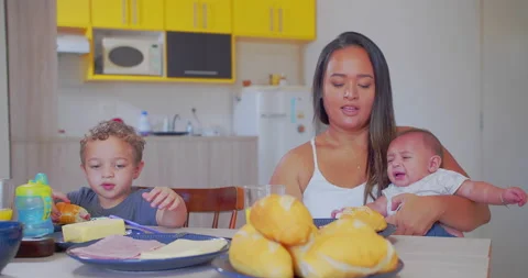 A mother serves breakfast to her two young children Stock-Footage 171223641