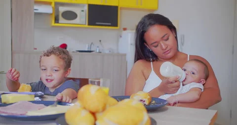 A mother serves breakfast to her two young children Stock-Footage 171227990