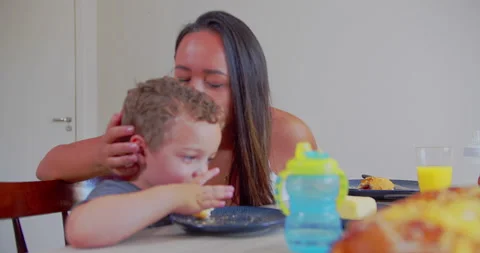 A mother serves breakfast to her two young children Stock-Footage 171232558