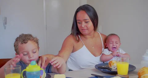 A mother serves breakfast to her two young children Stock-Footage 171239853
