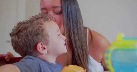 A mother is serving breakfast to her son and cuddling him Stock-Footage 171231825