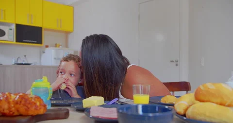 A mother is serving breakfast to her son and cuddling him Stock-Footage 171232442
