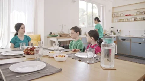 Mother serving breakfast - a plate full of pancakes for her children Stock Footage 133938963