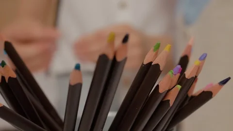Mother sharpening colored pencils for creative activities at home Stock Footage 329227643
