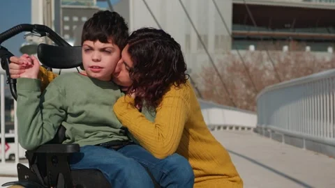 Mother showing affection to disabled son in wheelchair Stock Footage 302794986