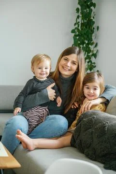 Mother with siblings looking at camera, spending fun time at home Stock Photos