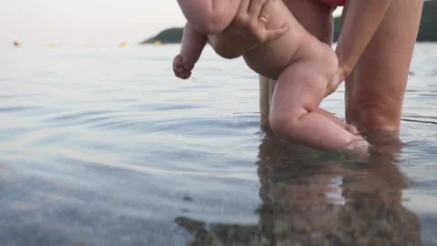 Mother with a small charming son bathe in the sea, happy family Stock Footage 132670312