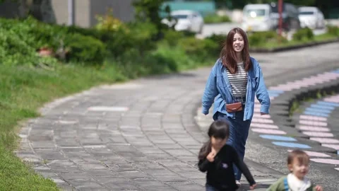 Mother smiles walking with two young children Stock-Footage 339845635