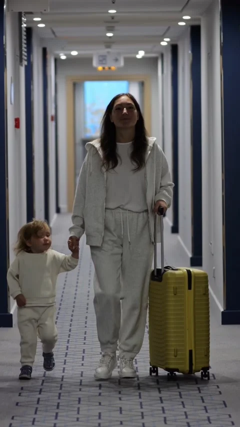 Mother Smiling Walking Toward Camera Travel, Bright Corridor Approach With 스톡 동영상 332644568