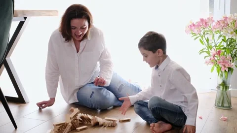 Mother with son playing game of physical skill Tower Stock Footage 155709056