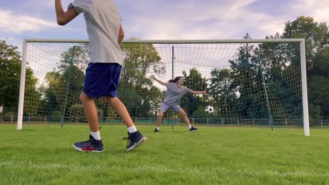 Mother, son playing soccer for fun outdo... | Stock Video | Pond5