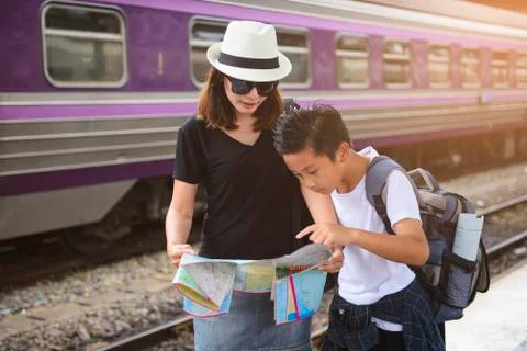 Mother with son using generic local map at a train station Stock Photos
