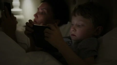 Mother with son using modern devices before sleep Stock-Footage 50961381