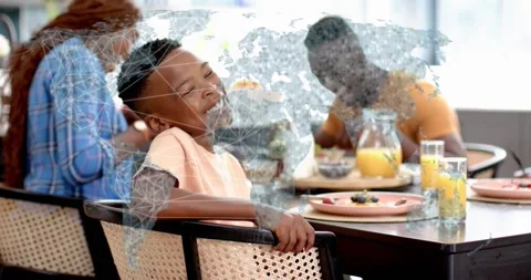 Mother speaking to boy at table while tech world map overlay evolving into Video stock 318918229