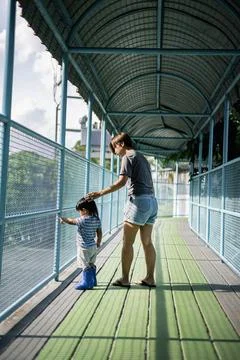 Mother Stands Next To Her Son In The Zoo Stock Photos