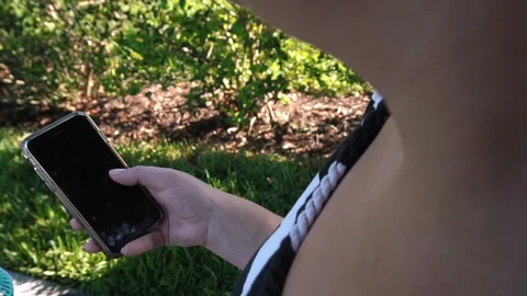 Mother with stroller on sidewalk looking through her phone Stock Footage 129382659