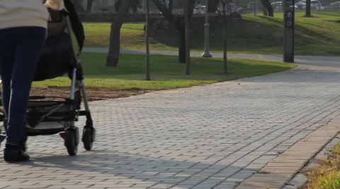 Mother with stroller walks in the park Stock Footage 33790033