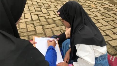 Mother Supporting Daughter’s Study Time in the Park Stock Footage 323248783
