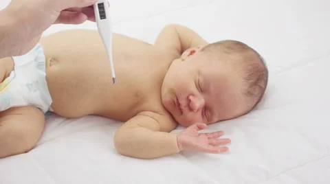Mother taking her babies temperature 스톡 동영상 68970974