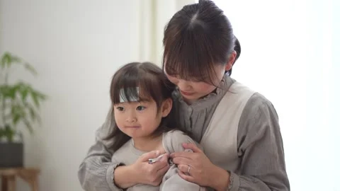 Mother taking her child's temperature Stock Footage 290850669