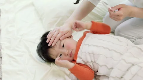 A Mother Taking Her Son's Temperature Video stock 327596134