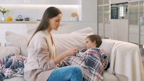 Mother is taking temperature of her son Stock Footage 149112345