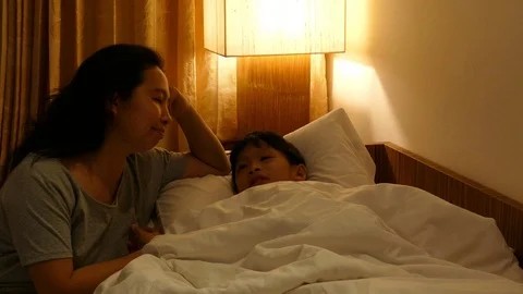 Mother talking with her son at bedtime Stock Footage 75979014