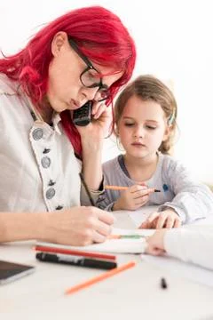 Mother Talking on the Phone While Drawing as Kid Watches Stock Photos