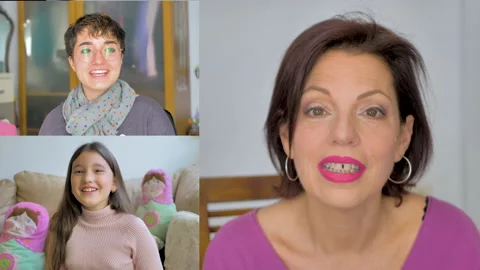 Mother talks happily with her two daughters through a video conference Stock Footage 148781176