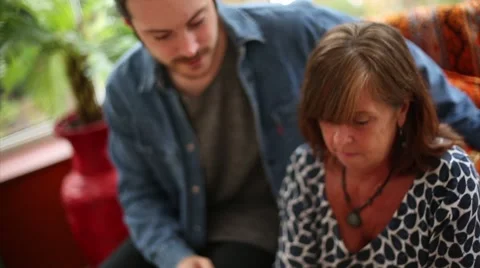 Mother Taught How to Use Tablet by Son Stock Footage 53472823