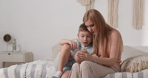 The mother teaches the eldest son to take care of the younger one. Caring for Stock-Footage 159263526