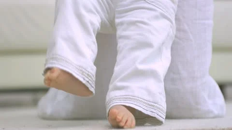 Mother teaching baby to walk Stock Footage