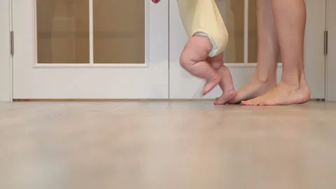 Mother Is Teaching Her Child To Do The First Steps. Stock Footage 86231108