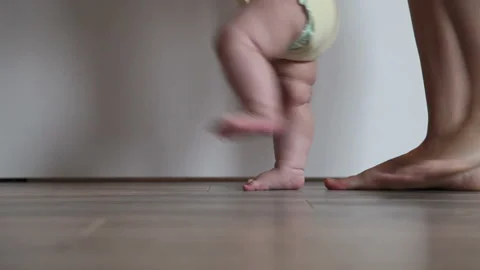 Mother Is Teaching Her Child To Do The First Steps. Close-up On Feet. Stock Footage 86231233